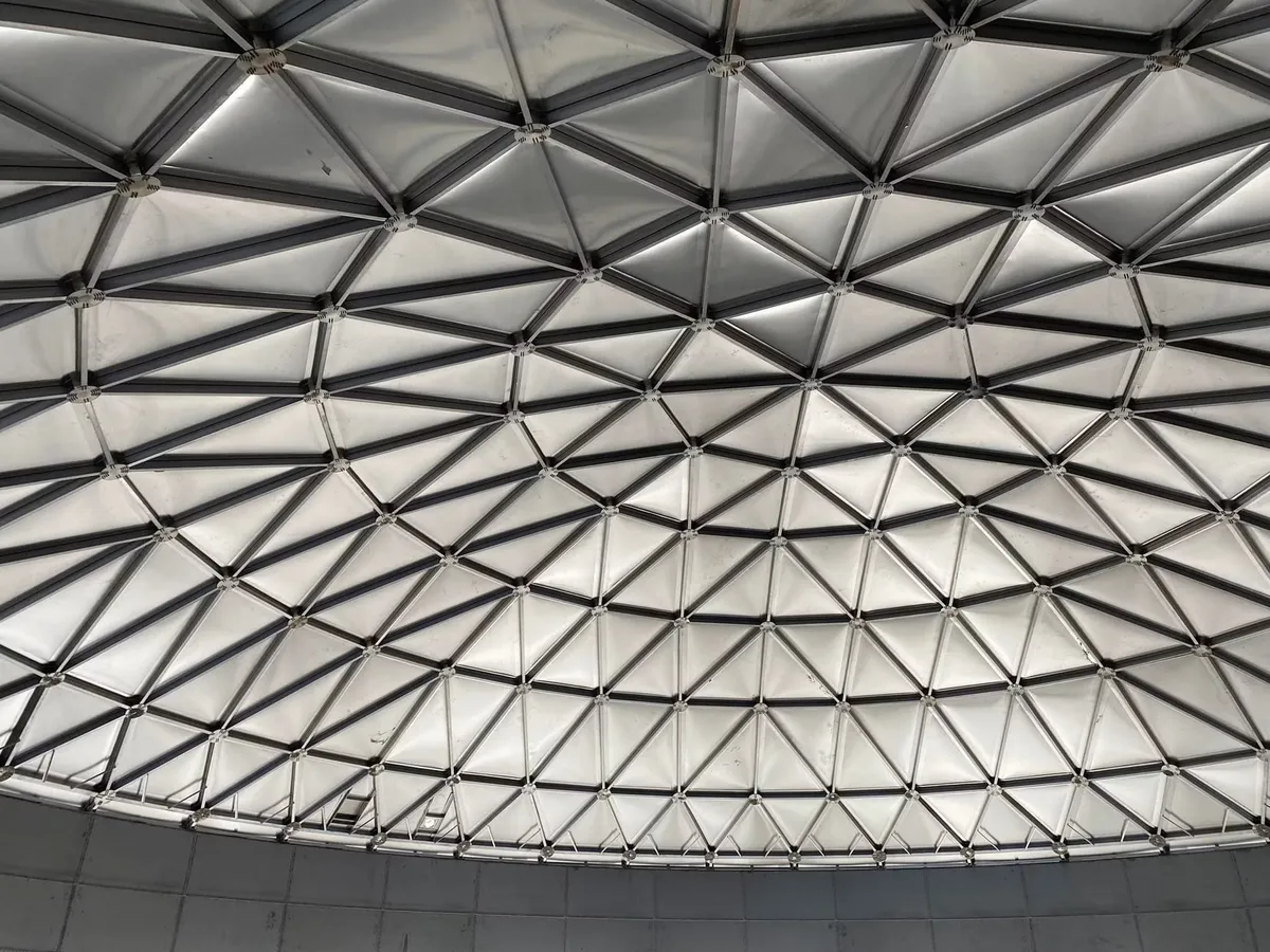 Aluminium geodesic dome roof seen from inside a completed tank