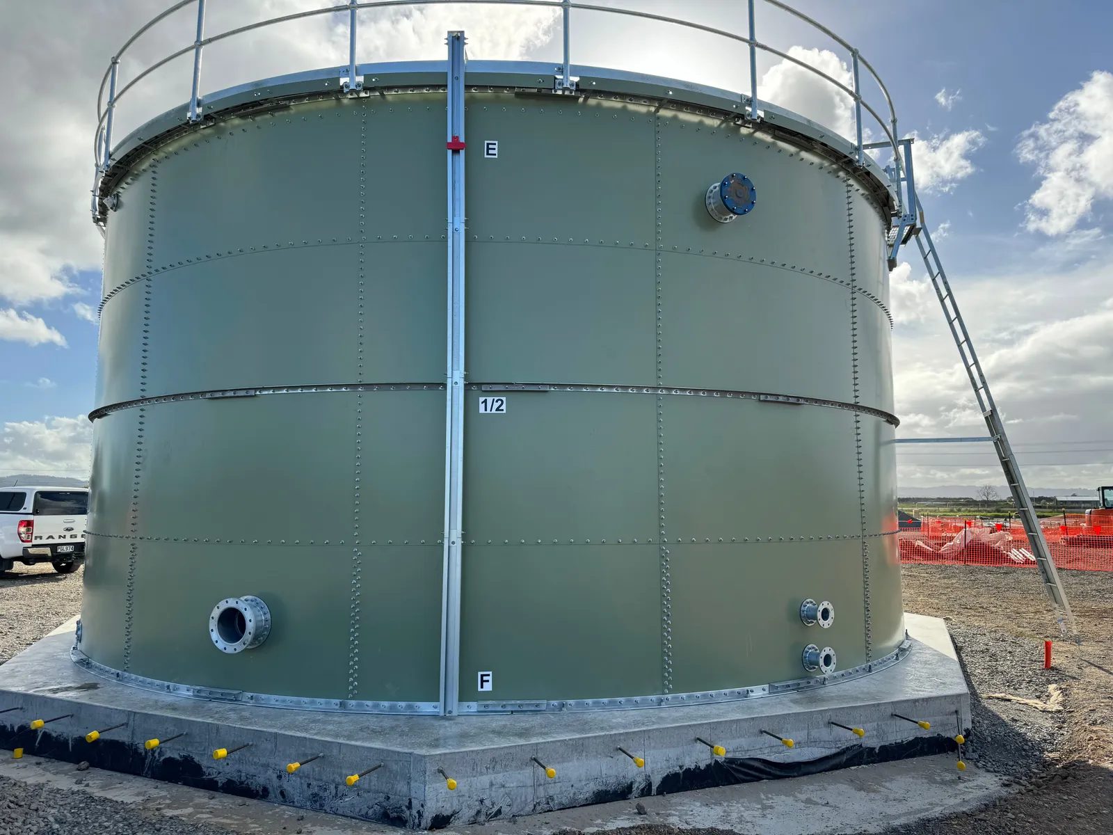 Completed green bolted steel tank on a concrete ring beam