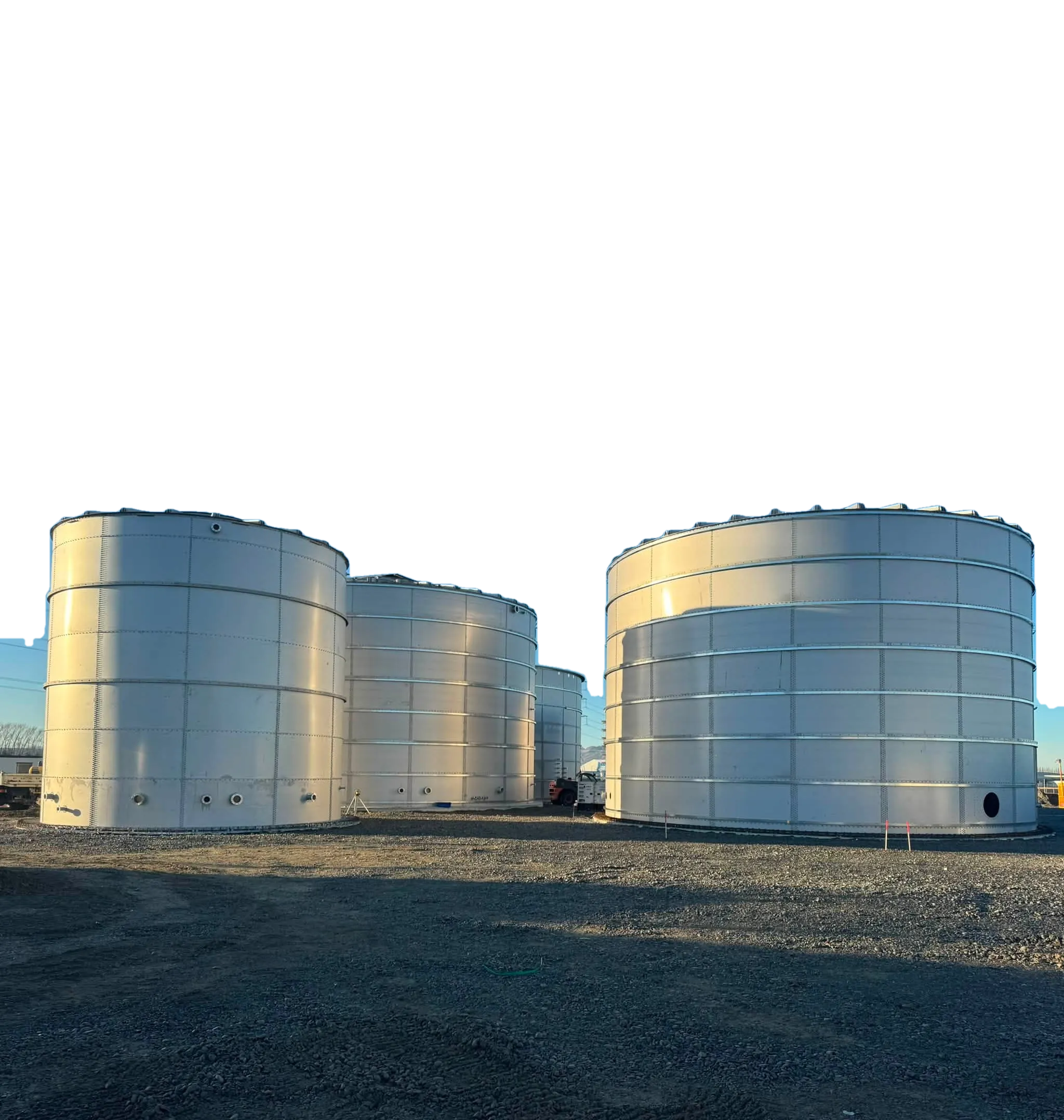 Four completed bolted steel tanks on a New Zealand site