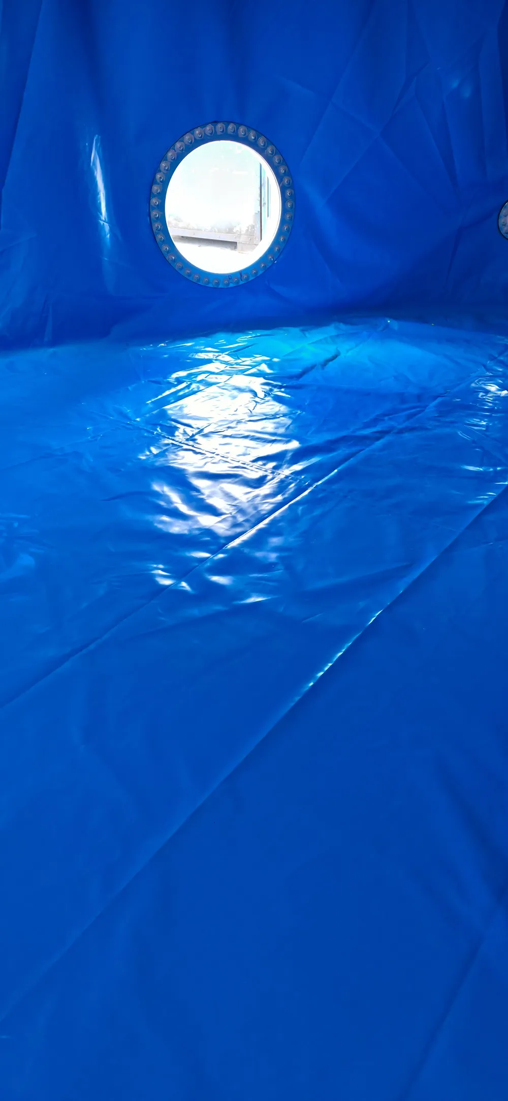 Blue potable grade liner and open manway inside a tank