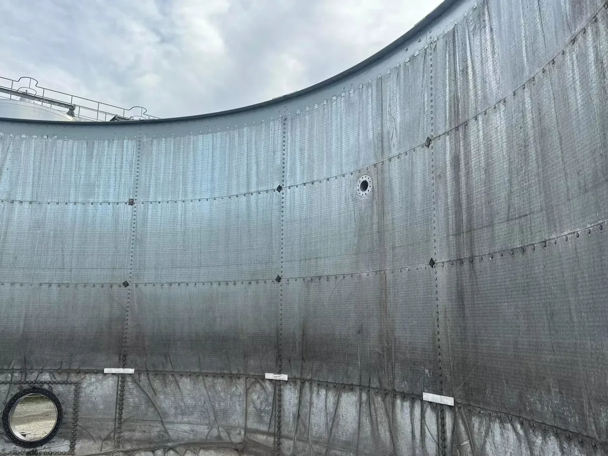 Galvanised bolted tank wall showing panel seams and bolt lines