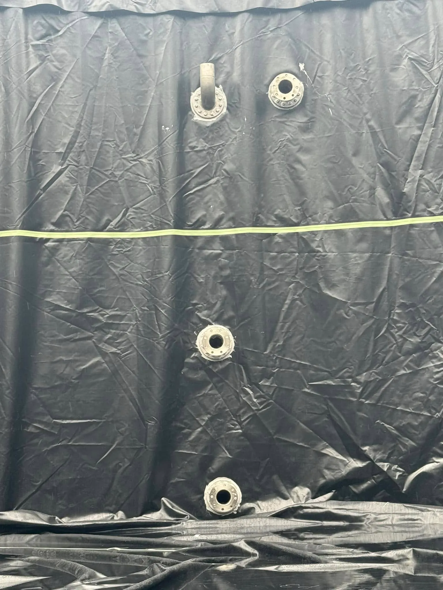 Outlet and pipework fittings sealed through the new liner on the tank wall